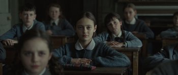 Movie still from “Never Let Me Go” (2010), directed by Mark Romanek – A group of young people sitting at a table; Medium shot, Over the shoulder angle