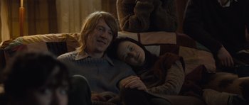 Movie still from “Never Let Me Go” (2010), directed by Mark Romanek – A man and a woman laying on a couch together; Medium shot, Overhead angle