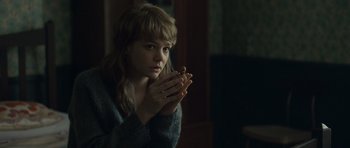 Movie still from “Never Let Me Go” (2010), directed by Mark Romanek – A woman holding her hands up to her face; Close Up shot, Over the shoulder angle