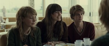 Movie still from “Never Let Me Go” (2010), directed by Mark Romanek – A group of people sitting around a table; Medium shot, Over the shoulder angle