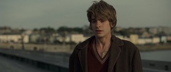 Movie still from “Never Let Me Go” (2010), directed by Mark Romanek – A young man with long hair and a brown jacket; Close Up shot, Over the shoulder angle