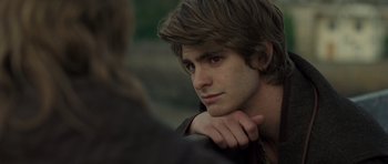 Movie still from “Never Let Me Go” (2010), directed by Mark Romanek – A young man with long hair is looking into the distance; Close Up shot, Over the shoulder angle