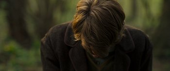 Movie still from “Never Let Me Go” (2010), directed by Mark Romanek – A person with a brown coat and a brown jacket; Close Up shot, Over the shoulder angle