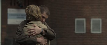 Movie still from “Never Let Me Go” (2010), directed by Mark Romanek – A man and a woman hug in front of a brick building; Medium shot, Over the shoulder angle
