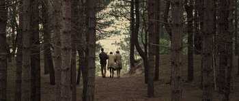 Movie still from “Never Let Me Go” (2010), directed by Mark Romanek – A group of people walking through the woods; Extreme Wide shot, High angle