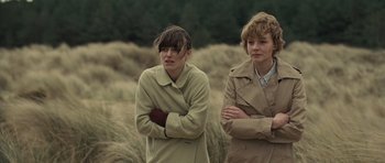 Movie still from “Never Let Me Go” (2010), directed by Mark Romanek – Two women standing next to each other in a field; Medium shot, Over the shoulder angle