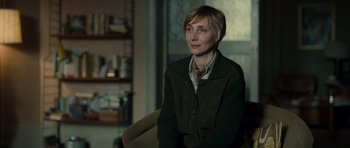 Movie still from “Never Let Me Go” (2010), directed by Mark Romanek – A woman sitting on a chair in a room; Medium shot, Over the shoulder angle