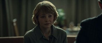 Movie still from “Never Let Me Go” (2010), directed by Mark Romanek – A young boy with blonde hair sitting in a dark room; Close Up shot, Over the shoulder angle
