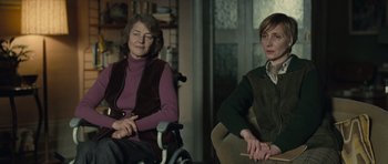 Movie still from “Never Let Me Go” (2010), directed by Mark Romanek – Two women sitting in a room next to each other; Medium shot, Over the shoulder angle