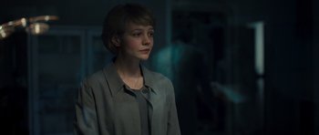 Movie still from “Never Let Me Go” (2010), directed by Mark Romanek – A woman in a gray shirt and a blue shirt; Close Up shot, Over the shoulder angle