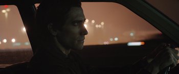 Movie still from “Nightcrawler” (2014), directed by Dan Gilroy – A person in a car at night; Close Up shot, Over the shoulder angle
