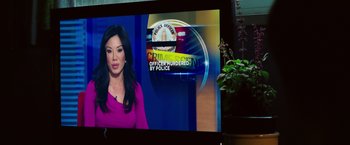 Movie still from “Nightcrawler” (2014), directed by Dan Gilroy – A news anchor is on a television screen; Close Up shot, High angle