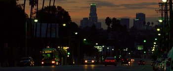 Movie still from “Nightcrawler” (2014), directed by Dan Gilroy – A city street at night with cars driving down the street; Extreme Wide shot, Low angle