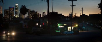 Movie still from “Nightcrawler” (2014), directed by Dan Gilroy – A city street with a building lit up at night; Extreme Wide shot, Low angle