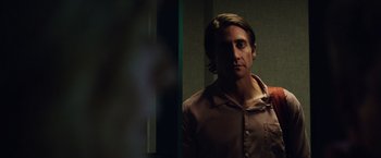 Movie still from “Nightcrawler” (2014), directed by Dan Gilroy – A man standing in front of a mirror in a room; Close Up shot, Over the shoulder angle