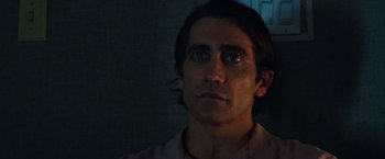 Movie still from “Nightcrawler” (2014), directed by Dan Gilroy – A person looking at the camera; Close Up shot, Low angle