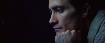 Movie still from “Nightcrawler” (2014), directed by Dan Gilroy – A person with his hand under his chin; Close Up shot, Low angle