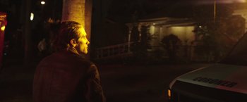 Movie still from “Nightcrawler” (2014), directed by Dan Gilroy – A man standing in the dark looking at a building; Medium shot, Low angle