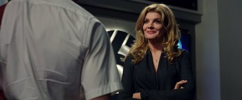 Movie still from “Nightcrawler” (2014), directed by Dan Gilroy – A woman standing next to a man in a room; Close Up shot, Over the shoulder angle