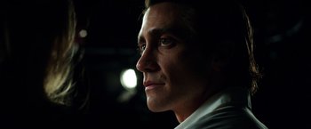 Movie still from “Nightcrawler” (2014), directed by Dan Gilroy – A man's face in the dark; Close Up shot, Low angle