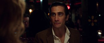 Movie still from “Nightcrawler” (2014), directed by Dan Gilroy – A person wearing a jacket; Close Up shot, Over the shoulder angle