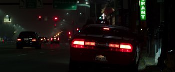 Movie still from “Nightcrawler” (2014), directed by Dan Gilroy – A red sports car driving down a street at night; Wide shot, Low angle