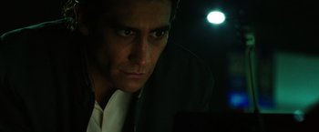 Movie still from “Nightcrawler” (2014), directed by Dan Gilroy – A person looking at the camera; Close Up shot, Low angle