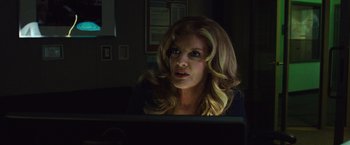 Movie still from “Nightcrawler” (2014), directed by Dan Gilroy – A woman sitting in front of a computer monitor; Close Up shot, Over the shoulder angle