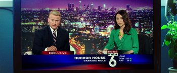 Movie still from “Nightcrawler” (2014), directed by Dan Gilroy – Two people sitting in front of a news desk; Medium shot, Low angle