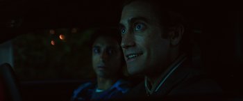 Movie still from “Nightcrawler” (2014), directed by Dan Gilroy – Two men sitting next to each other in a dark room; Close Up shot, Over the shoulder angle