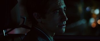 Movie still from “Nightcrawler” (2014), directed by Dan Gilroy – A person in a dark room; Close Up shot, Over the shoulder angle