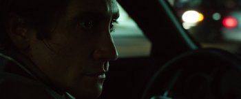 Movie still from “Nightcrawler” (2014), directed by Dan Gilroy – A person in a car looking out the window; Close Up shot, Low angle