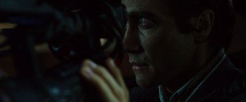 Movie still from “Nightcrawler” (2014), directed by Dan Gilroy – A person taking a picture with a camera; Close Up shot, Over the shoulder angle