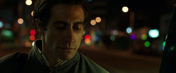 Movie still from “Nightcrawler” (2014), directed by Dan Gilroy – A person with his eyes closed; Close Up shot, Low angle