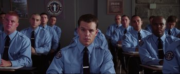 Movie still from “The Departed” (2006), directed by Martin Scorsese – A group of men sitting in front of each other wearing uniforms; Medium shot, Over the shoulder angle
