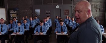 Movie still from “The Departed” (2006), directed by Martin Scorsese – A group of young men sitting at desks in a classroom; Medium shot, High angle