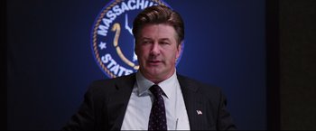 Movie still from “The Departed” (2006), directed by Martin Scorsese – A person wearing a suit and tie; Close Up shot, Low angle