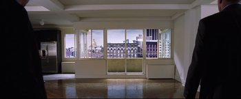 Movie still from “The Departed” (2006), directed by Martin Scorsese – A room with a view of a large city; Extreme Wide shot, High angle
