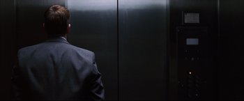 Movie still from “The Departed” (2006), directed by Martin Scorsese – A man standing in front of an elevator; Close Up shot, Low angle