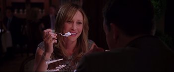 Movie still from “The Departed” (2006), directed by Martin Scorsese – A woman holding a spoon up to her mouth; Close Up shot, Over the shoulder angle
