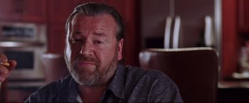 Movie still from “The Departed” (2006), directed by Martin Scorsese – A person sitting in a chair; Close Up shot, Over the shoulder angle