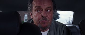 Movie still from “The Departed” (2006), directed by Martin Scorsese – An older man with a beard looking at the camera; Close Up shot, Over the shoulder angle
