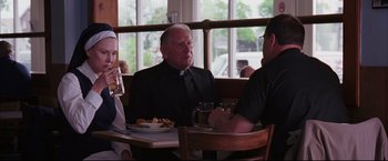 Movie still from “The Departed” (2006), directed by Martin Scorsese – Three people are sitting at a table in front of a window; Medium shot, Over the shoulder angle