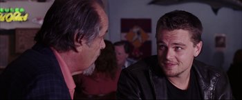 Movie still from “The Departed” (2006), directed by Martin Scorsese – A man in a leather jacket talking to another man in a leather jacket; Close Up shot, Over the shoulder angle