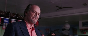 Movie still from “The Departed” (2006), directed by Martin Scorsese – An older man with a beard and a pink shirt; Close Up shot, Low angle