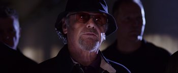 Movie still from “The Departed” (2006), directed by Martin Scorsese – An older man wearing a hat and sunglasses; Close Up shot, Low angle