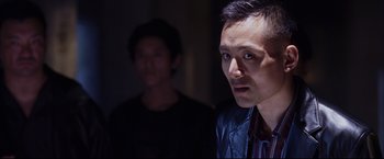 Movie still from “The Departed” (2006), directed by Martin Scorsese – A man standing next to another man in a dark room; Close Up shot, Over the shoulder angle