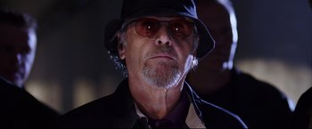 Movie still from “The Departed” (2006), directed by Martin Scorsese – An older man wearing a hat and sunglasses; Close Up shot, Low angle