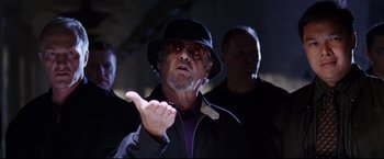Movie still from “The Departed” (2006), directed by Martin Scorsese – An older man wearing a black hat and a purple shirt; Close Up shot, Low angle