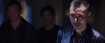 Movie still from “The Departed” (2006), directed by Martin Scorsese – A man in a leather jacket standing in front of another man; Close Up shot, Low angle